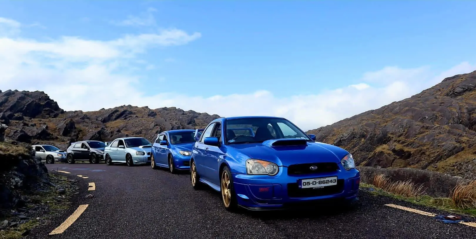 Blue Subaru Impreza leading a club run along a mountain road