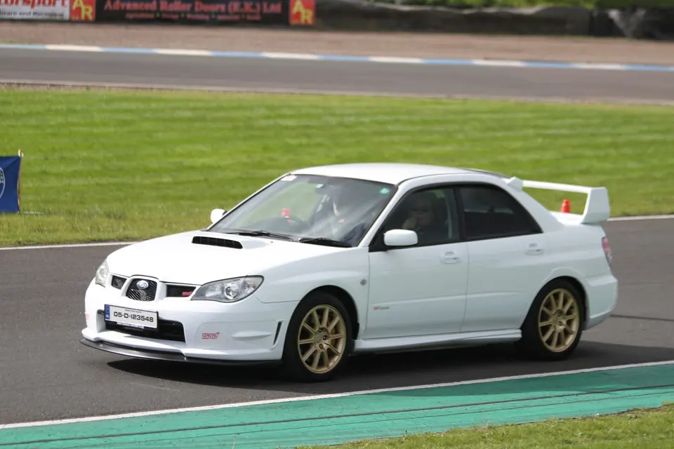 A white ISDC Subaru Impreza STI on track at Knockhill